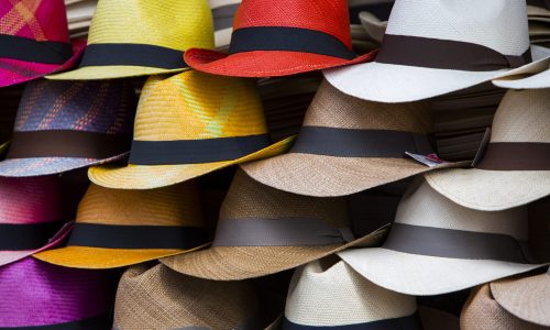 Group of colored hats for sale, hanging on a wall, Otavalo Market. Ecuador